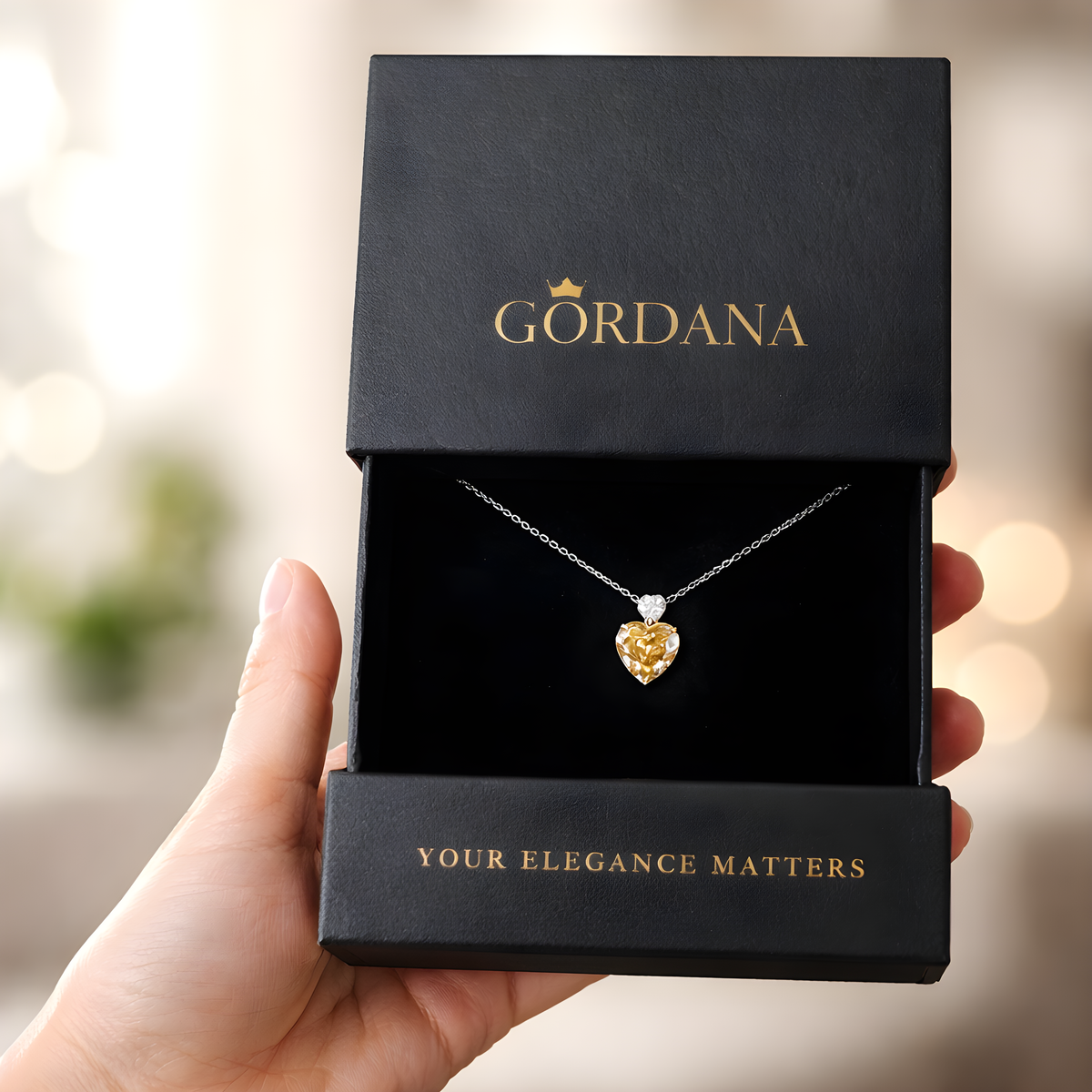 A luxury yellow Heart-shaped pendant S925 sterling silver necklace in a GORDANA box with a blurred background