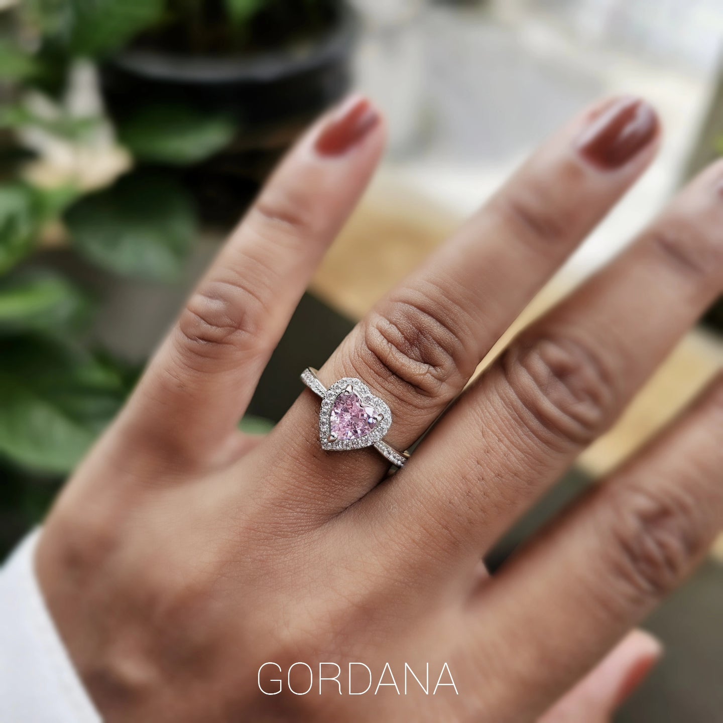 Sterling silver 925 pink heart cubic zirconia ring with white zirconia halo, worn on hand, bridal romantic style