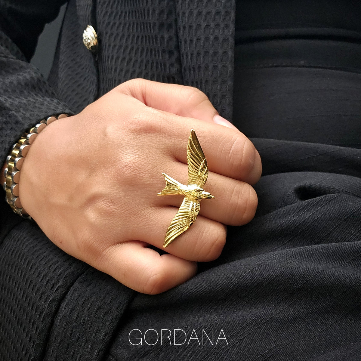 A person wearing a luxury gold bird wing adjustable stainless steel statement ring – Fearless Ring