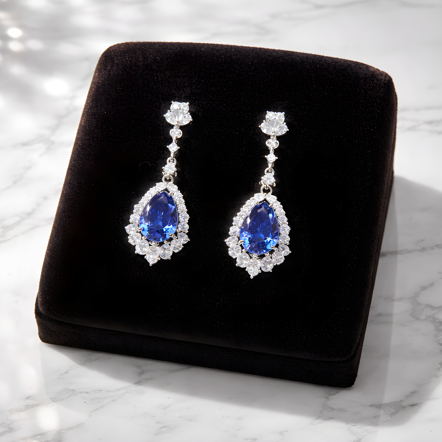 A pair of luxury S925 sterling silver tear drop earrings with blue sapphire stones and diamonds for women.