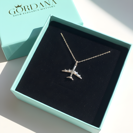 Silver airplane necklace in a GORDANA box on a light background
