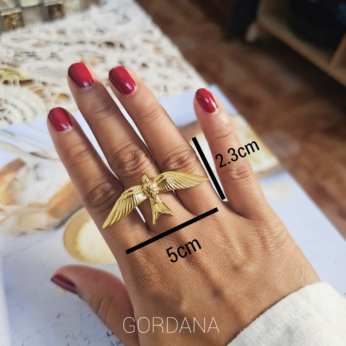 A person wearing a luxury gold bird wing adjustable stainless steel statement ring – Fearless Ring