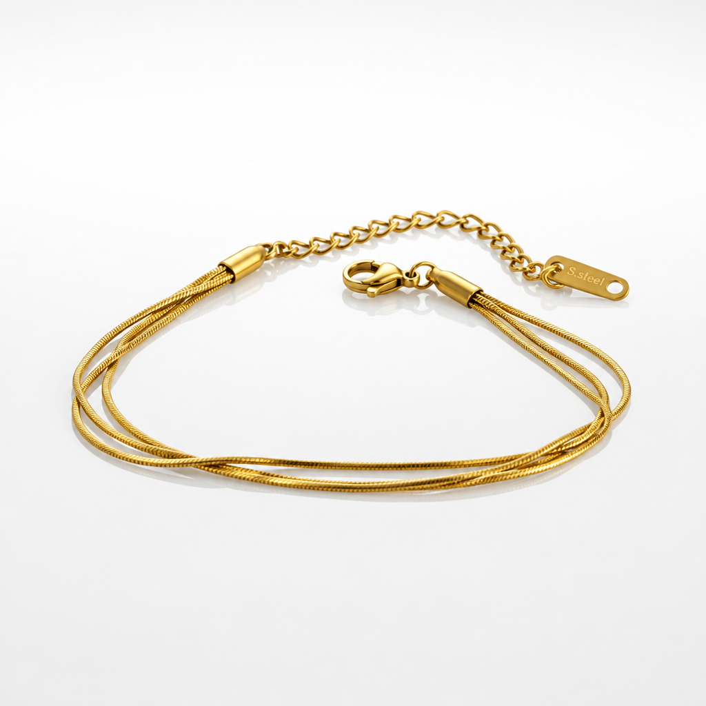 A gold multi-strand snake chain ankle bracelet with a lobster clasp and extension chain, displayed on a clean white background, minimalist anklet for woman. 
