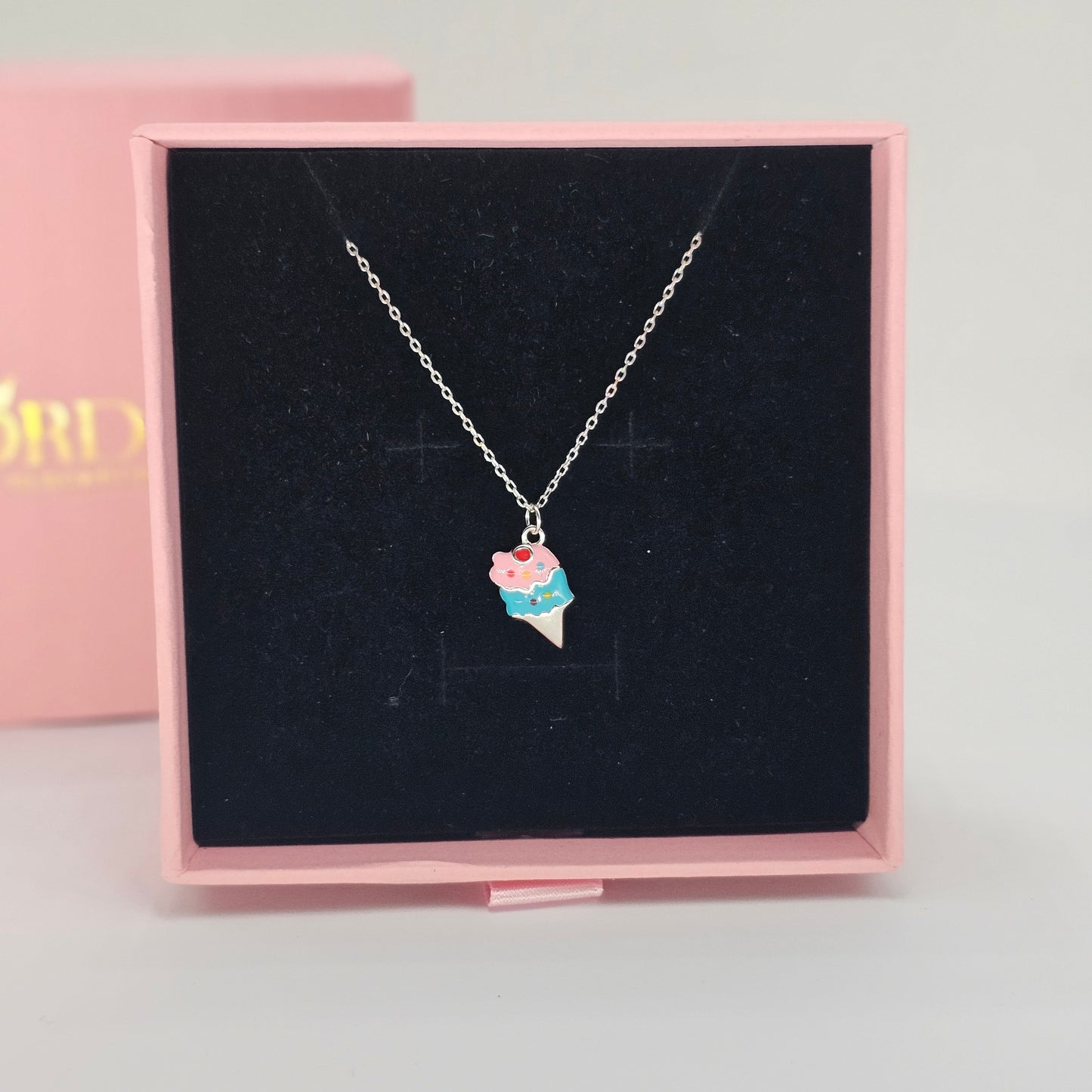 Silver jewelry ice cream pendant on a delicate stainless steel necklace, unisex fashion jewelry with colorful gemstone.