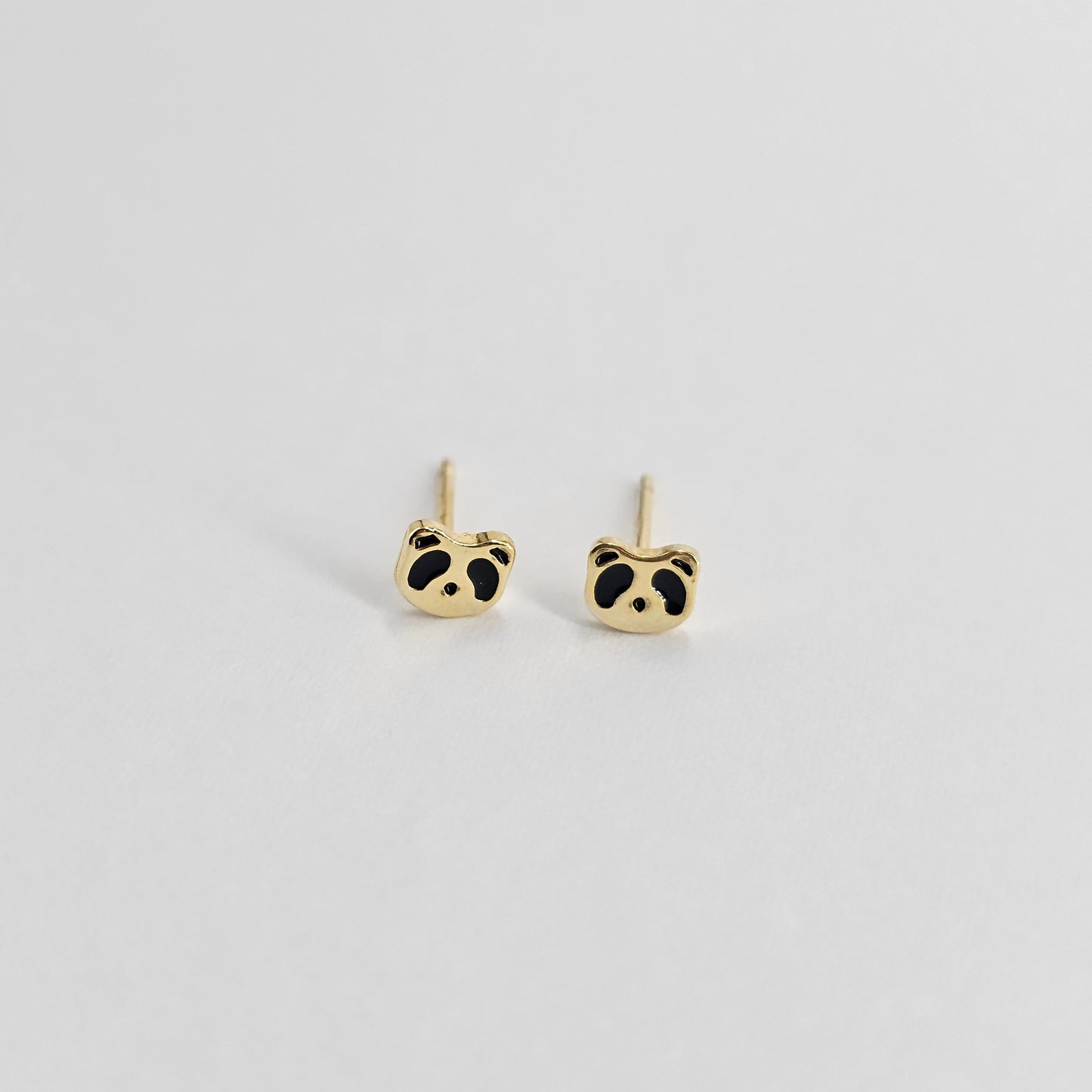 Gold panda-shaped stainless steel earrings with black enamel accents, unisex fashion jewelry.