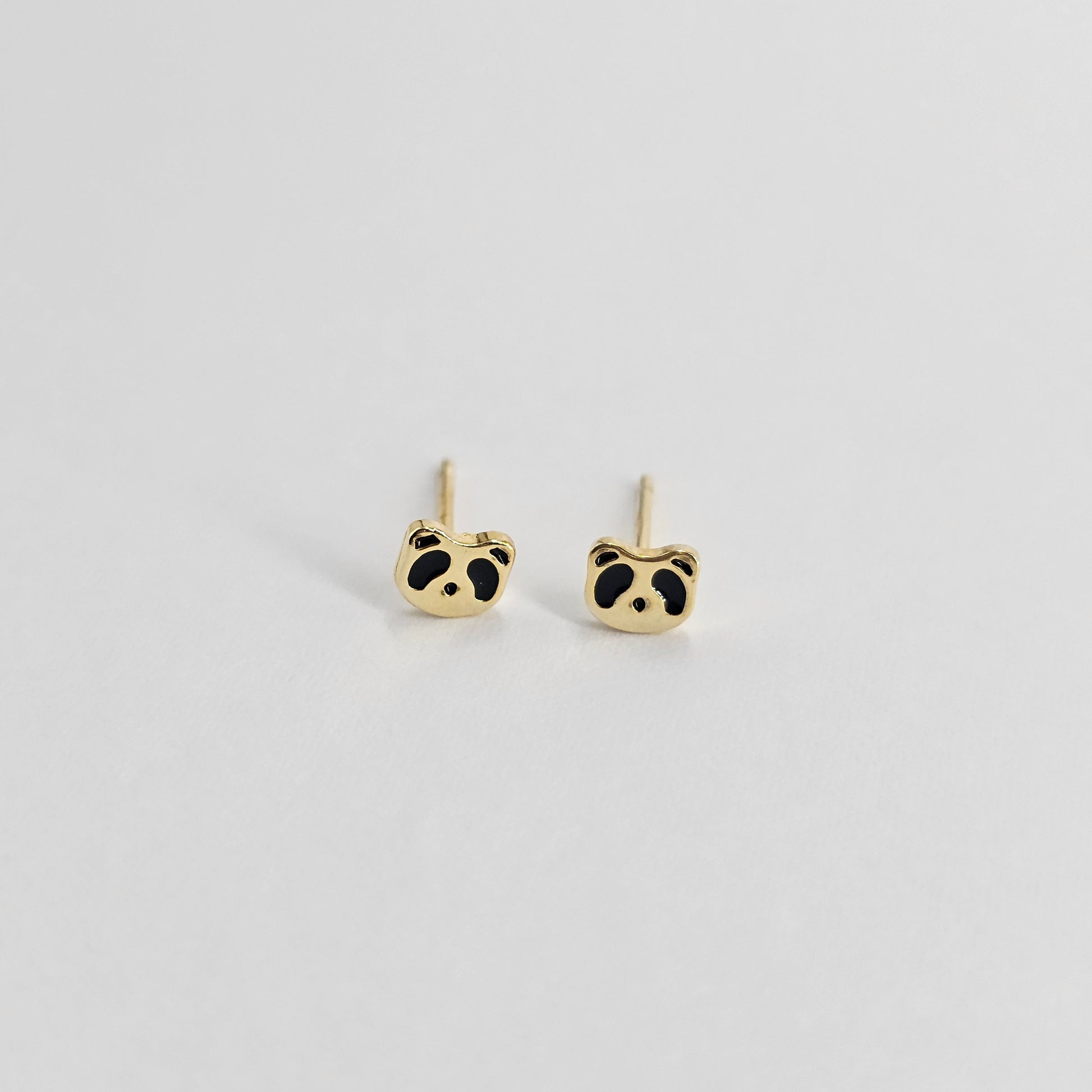 Gold panda-shaped stainless steel earrings with black enamel accents, unisex fashion jewelry.