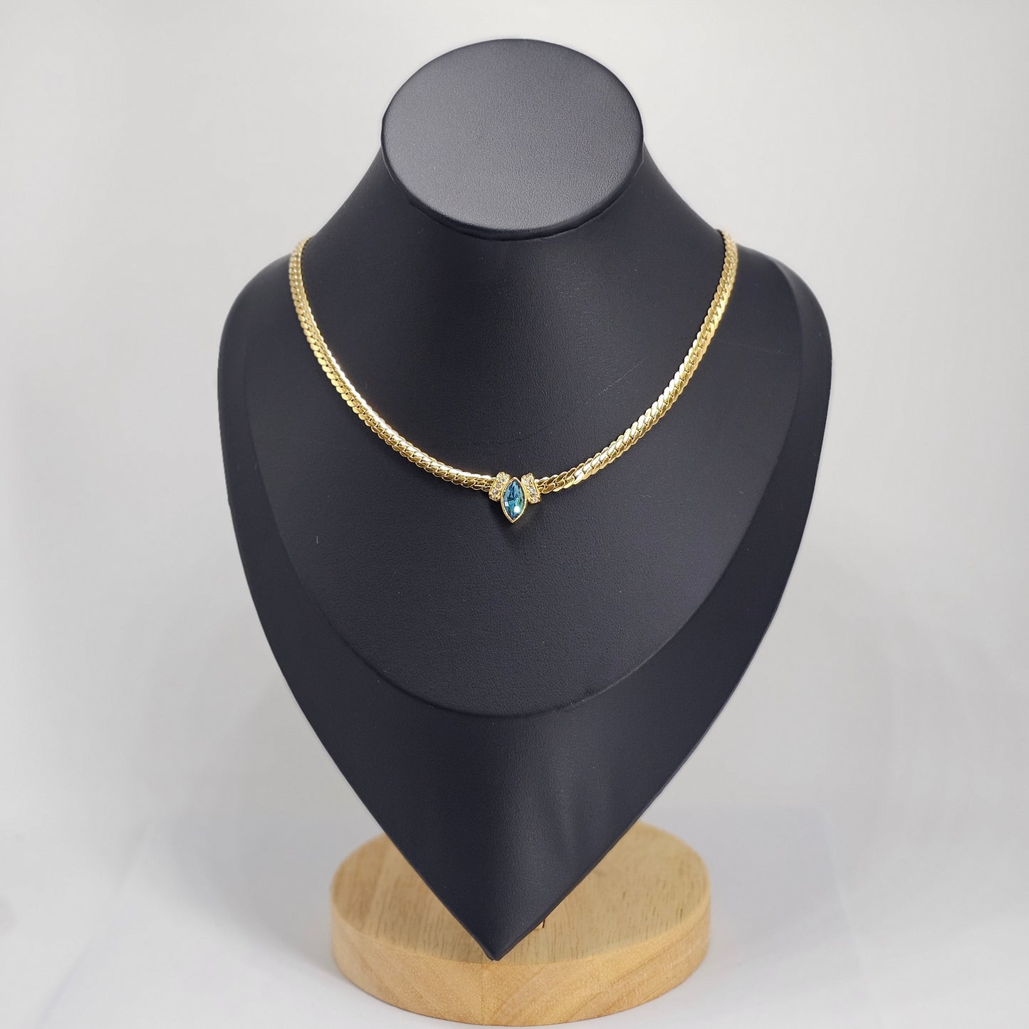 Elegant 18k gold plated stainless steel necklace with a blue gemstone pendant, unisex fashion jewelry.