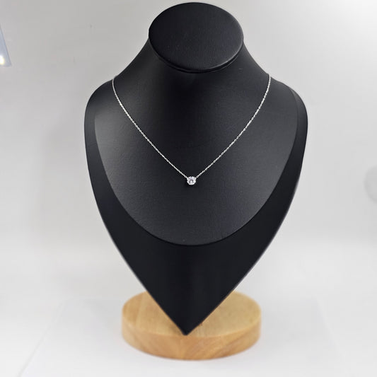 Delicate silver necklace with a single gemstone pendant, stainless steel jewelry, unisex fashion jewelry reflecting.