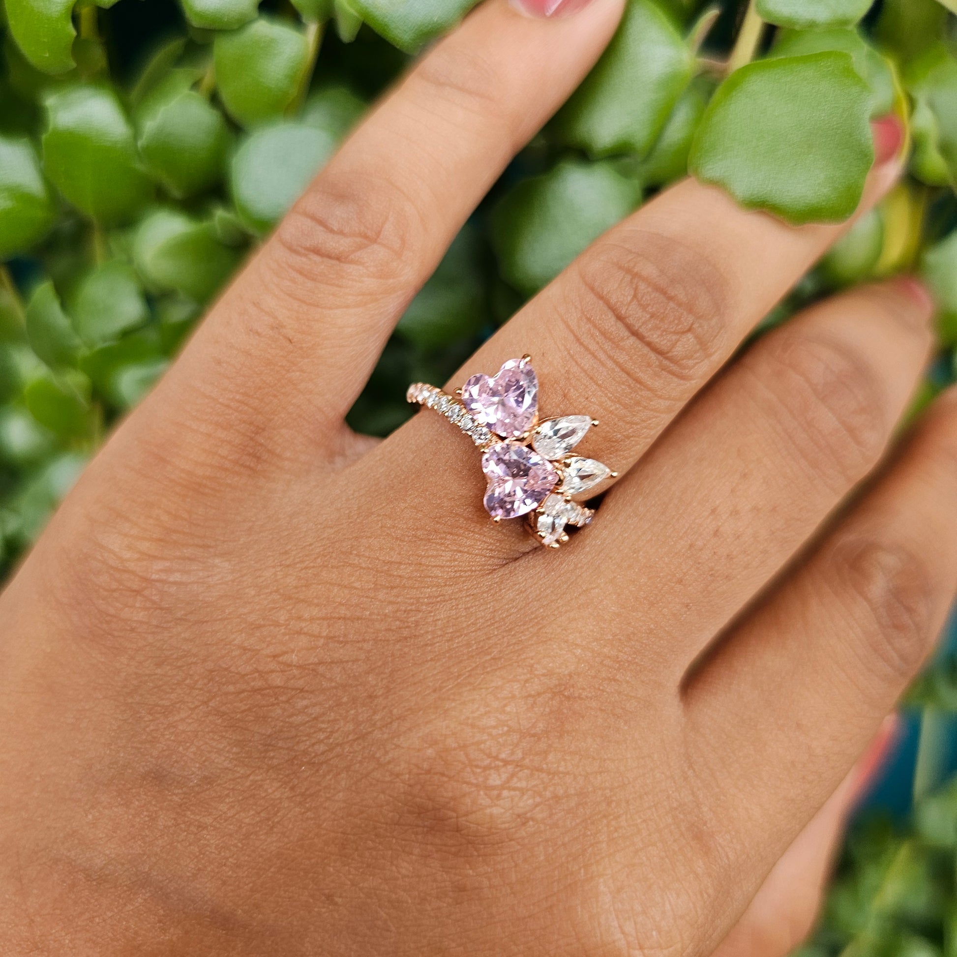 Rose gold stainless steel ring with purple gemstone hearts and clear stones, unisex fashion jewelry.
