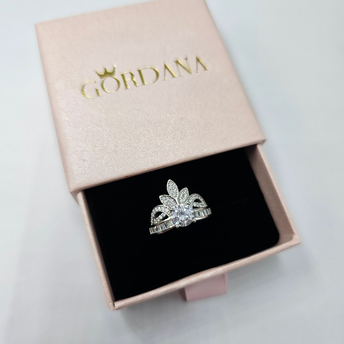 Silver jewelry queen crown ring with intricate gemstone design in a Mauritius Europe USA style box.