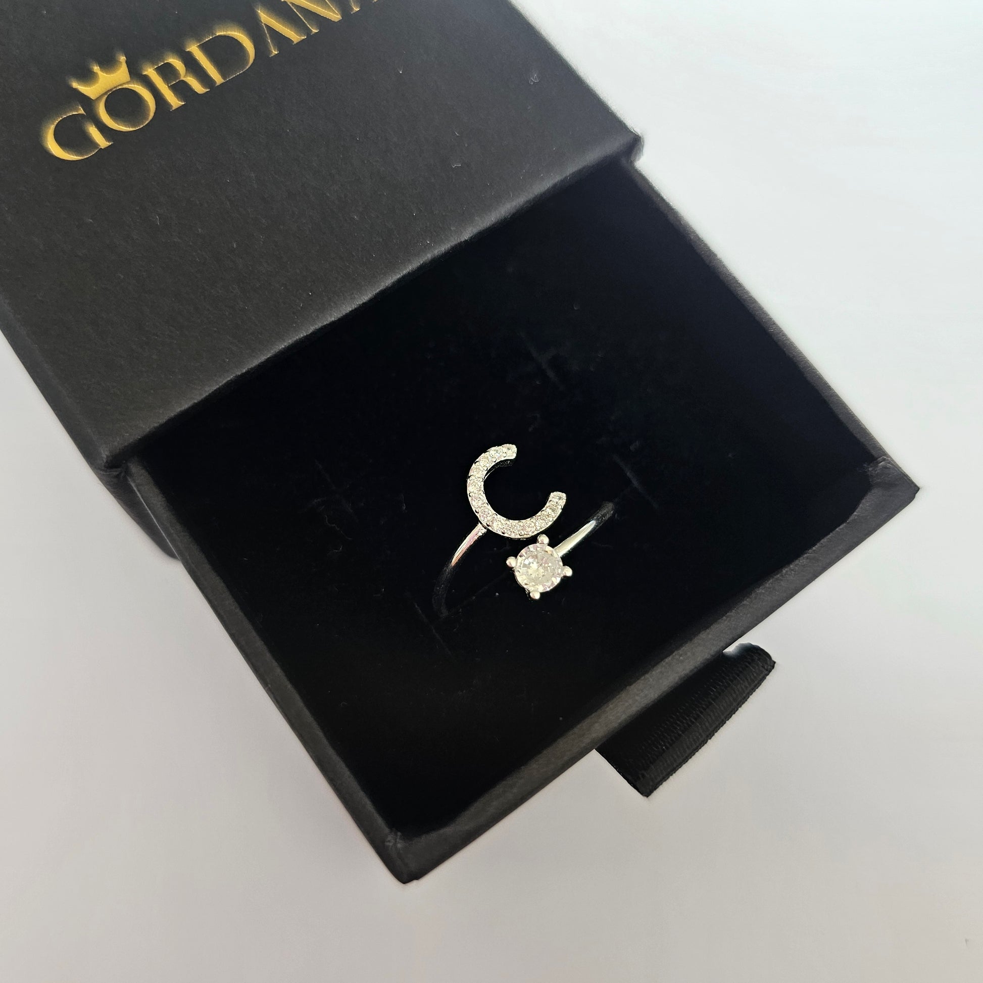 Silver alphabet C ring in stainless steel jewelry style with a small clear gemstone, unisex fashion jewelry.