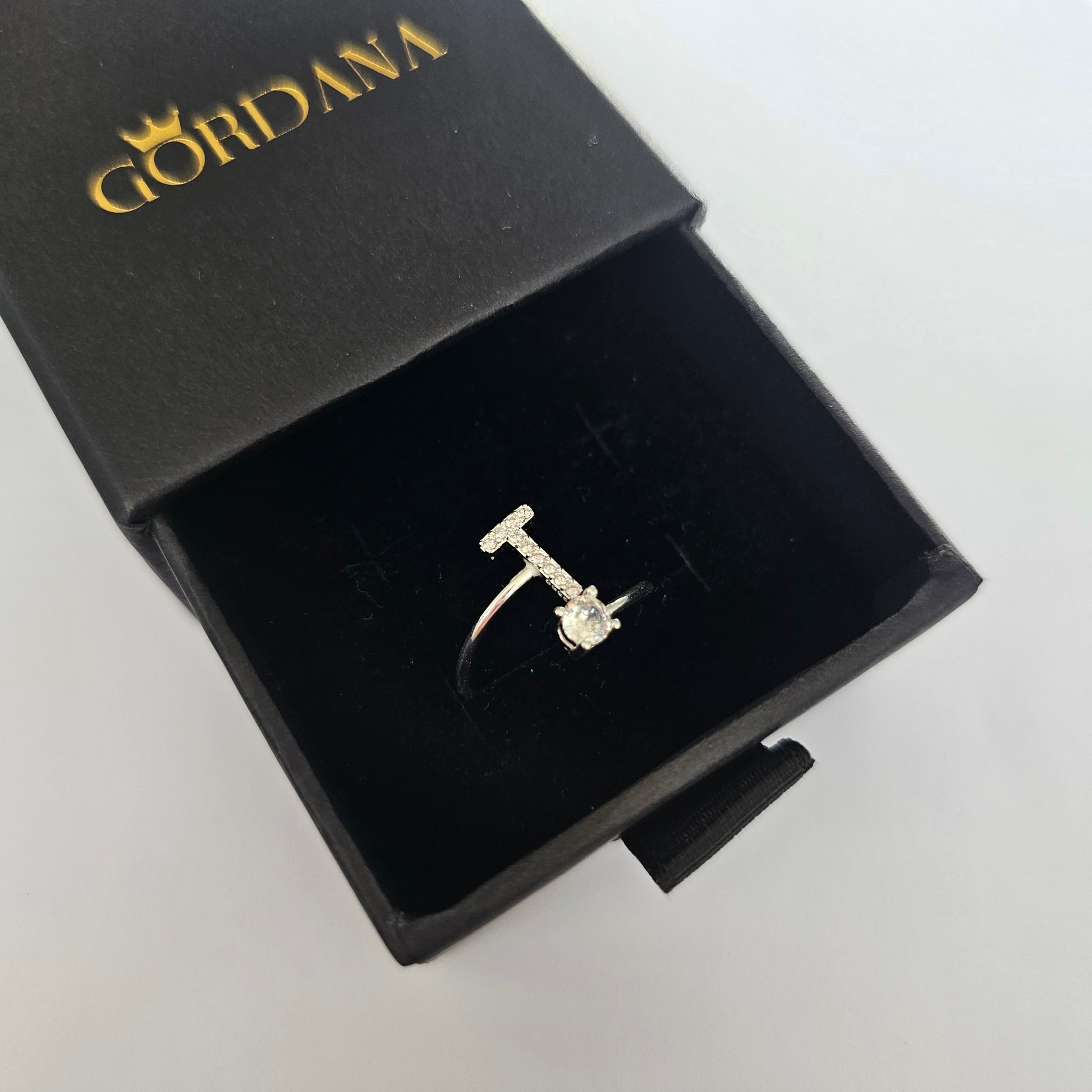 Silver alphabet ring featuring a gemstone, stainless steel jewelry with elegant, unisex fashion design from Mauritius Europe .