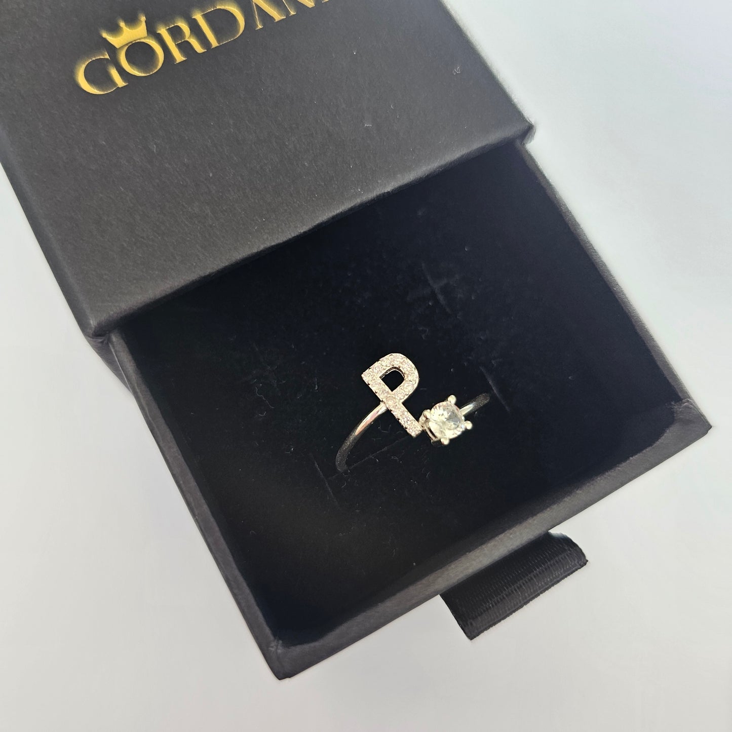 Silver stainless steel letter P ring with a small gemstone, unisex fashion jewelry in black box, Mauritius Europe USA style.