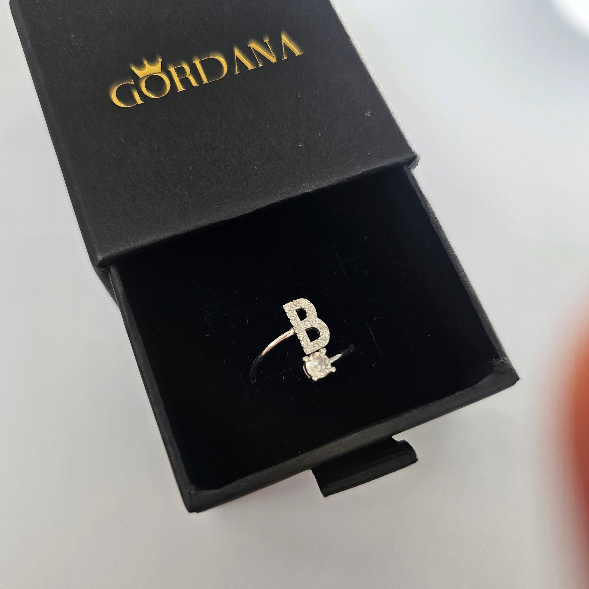 Silver stainless steel alphabet ring letter B in black Gordana branded box, unisex fashion jewelry.