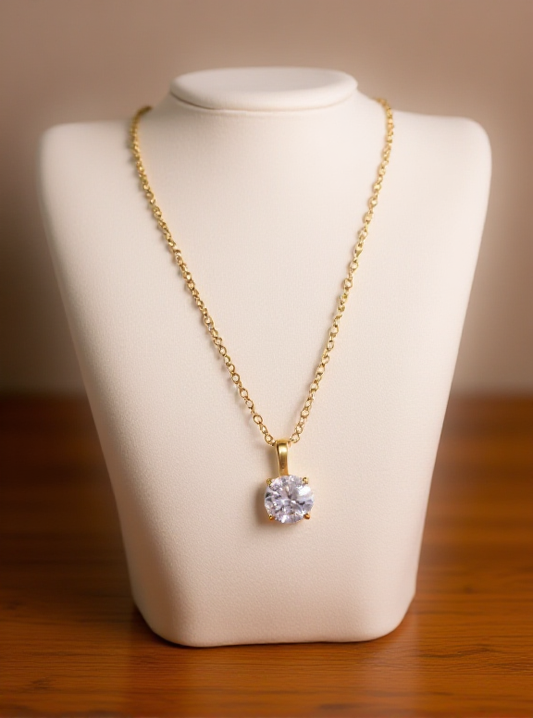 Gold necklace with a diamond pendant on a white stand against a wooden - surface - Necklace - stainless steel