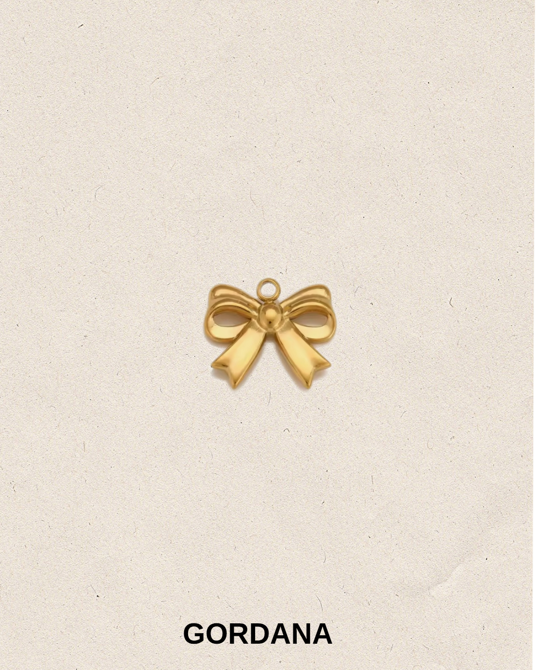 Gold plated stainless steel bow charm for bracelets and pendant necklaces in Mauritius and France.