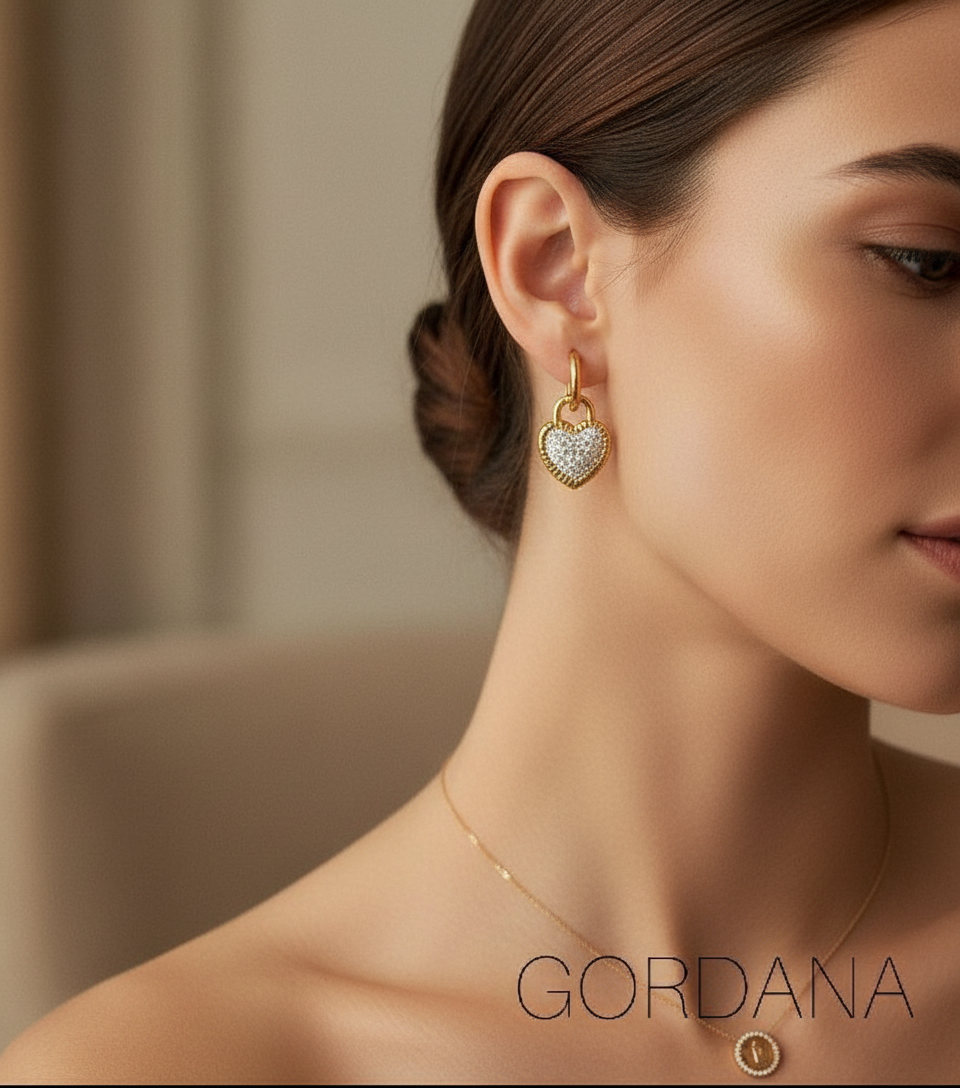 Close-up of a woman wearing a heart-shaped earring with 'Gordana' branding. Heart Lock stainless steel Earrings