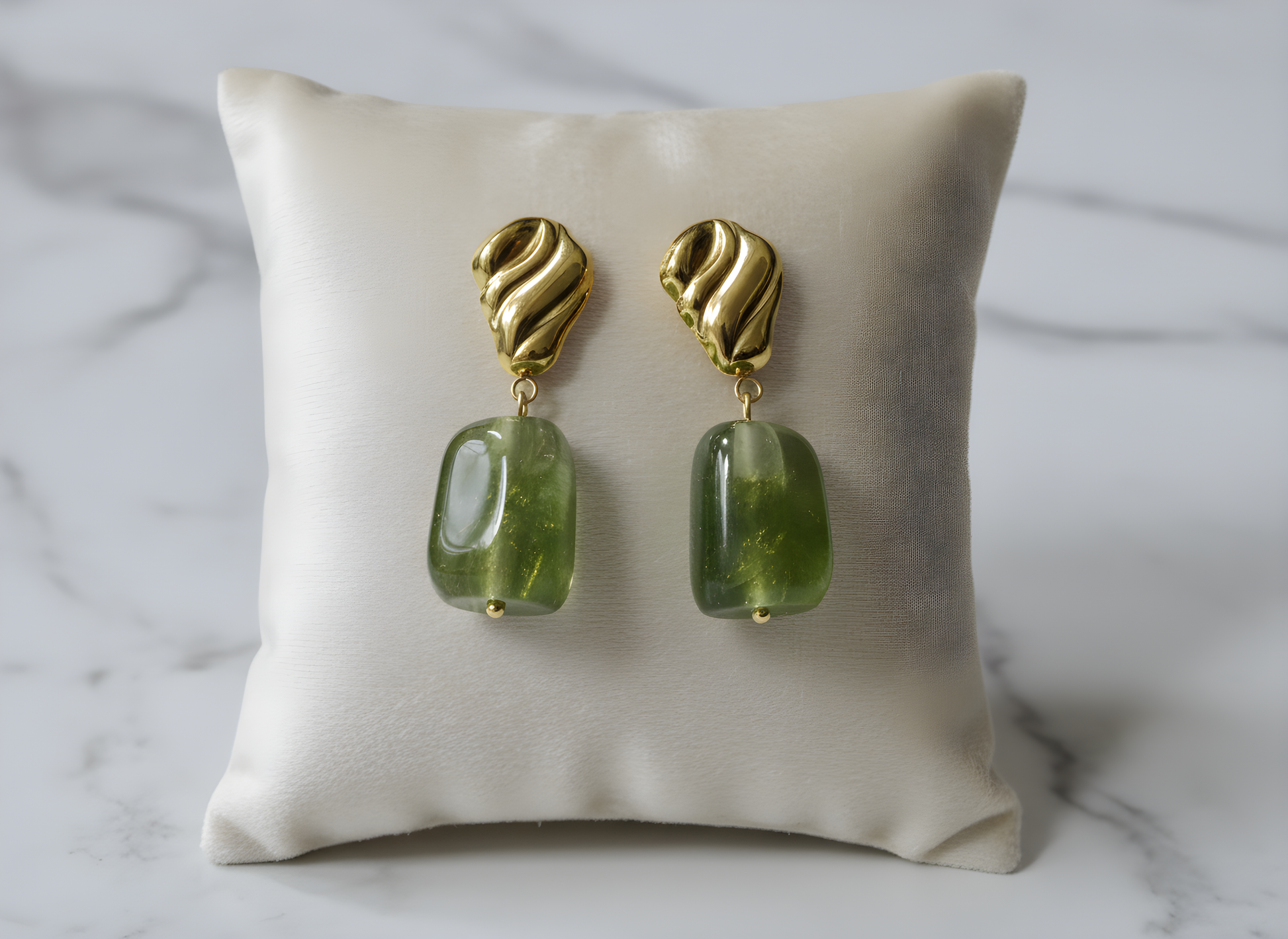 Gold earrings with green gemstones on a beige pillow against a marble background - Drop dangle earrings - stainless steel