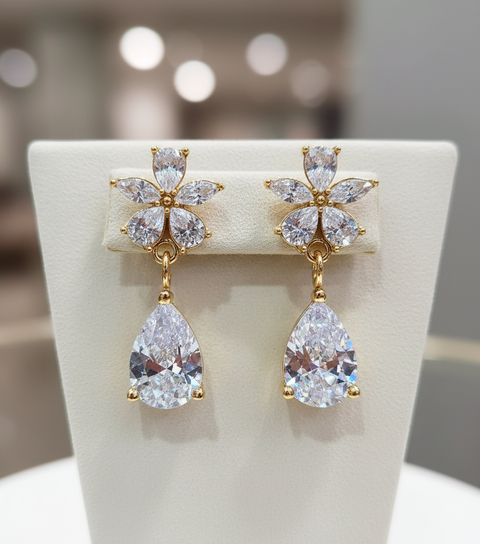 Gold and crystal earrings on a white stand with a blurred background - Flower Earrings - stainless steel Mauritius France