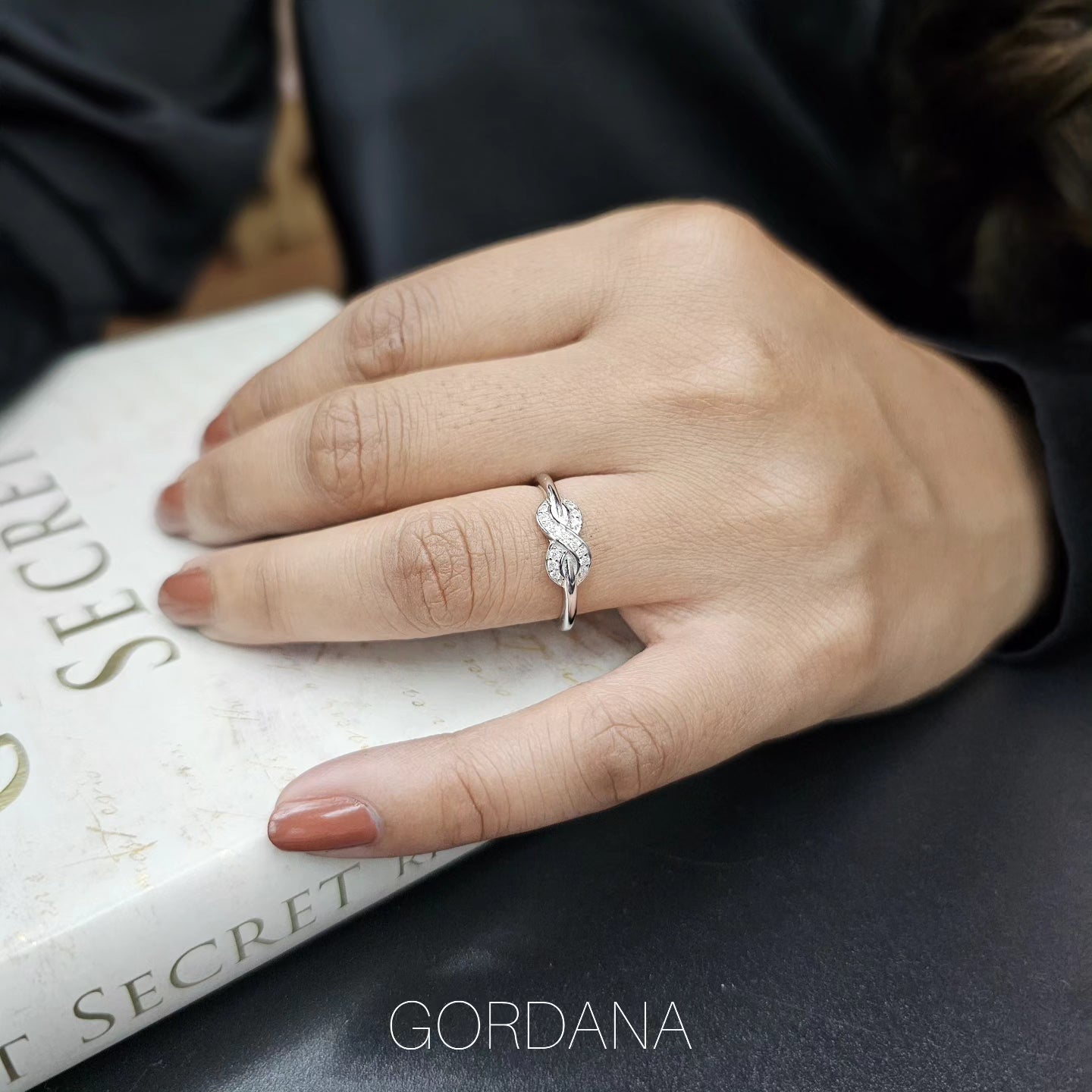 Silver stainless steel promise ring with twisted band and central gemstone, unisex fashion jewelry.