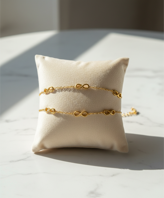 Gold bracelet on a white pillow with a soft background Infinity Bracelet - stainless steel