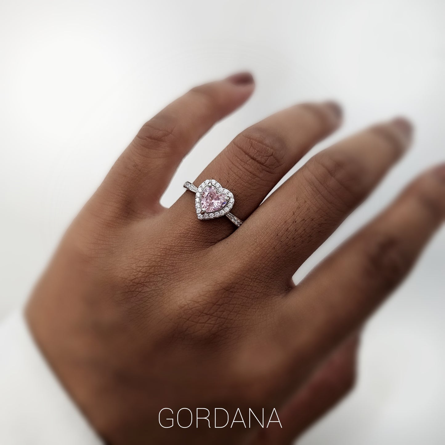 Silver jewelry heart-shaped ring with pink gemstone, stainless steel fashion jewelry, unisex design inspired by Mauritius.