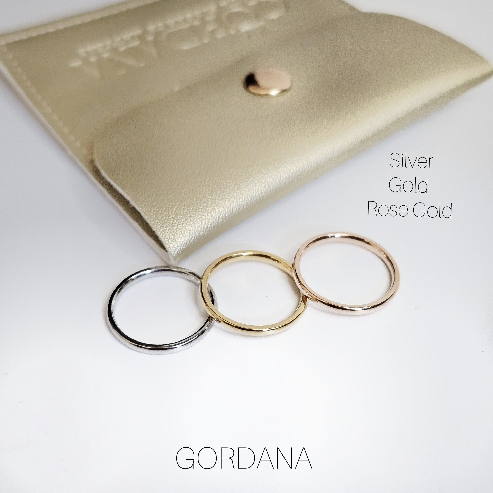 Set of three elegant stainless steel rings in silver, gold, and rose gold with slim, minimalist design, perfect unisex.