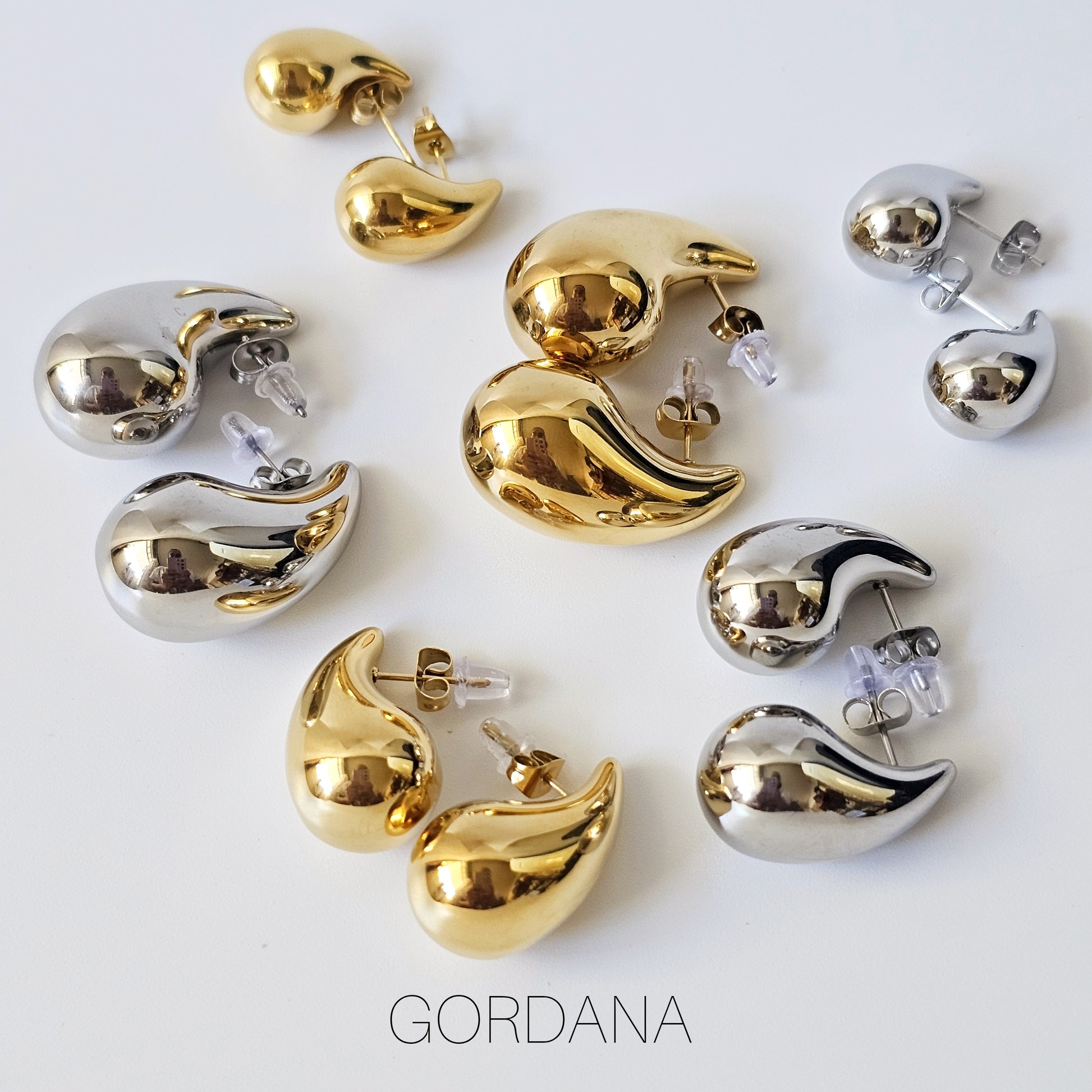 Gold and silver 18K gold plated stainless steel Bottega earrings in teardrop shapes, unisex fashion jewelry.