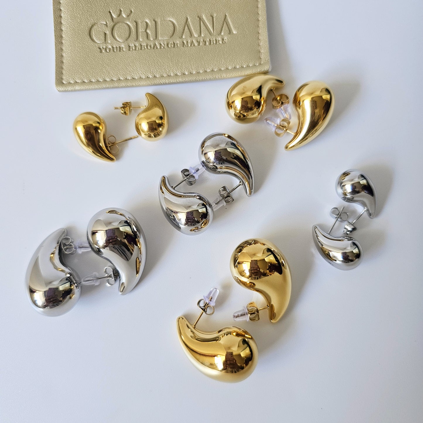 Elegant Bottega earrings in polished 18K gold plated and silver stainless steel, unisex fashion jewelry.