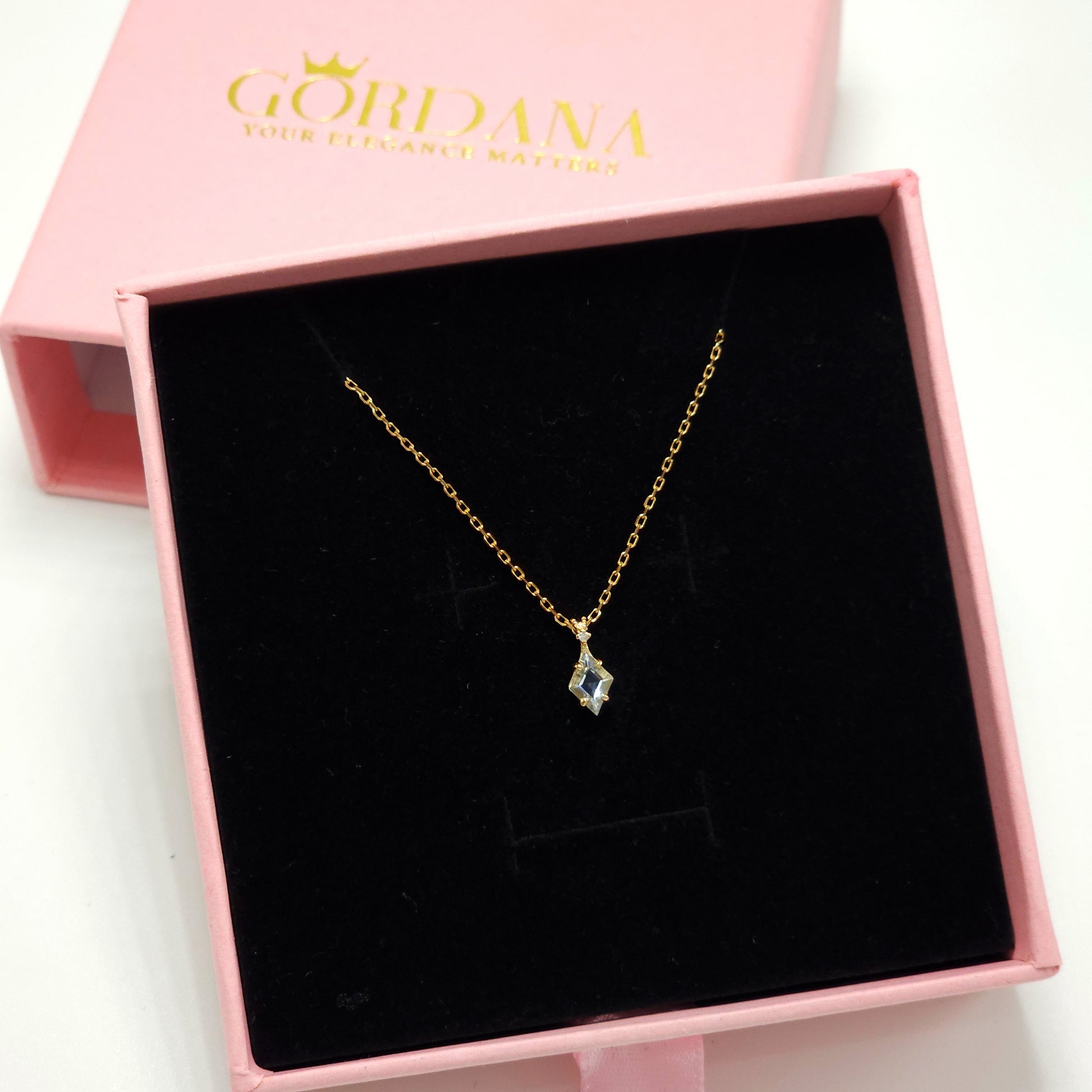 Silver and gold-tone stainless steel necklace with sky blue topaz gemstone, elegant unisex fashion jewelry.