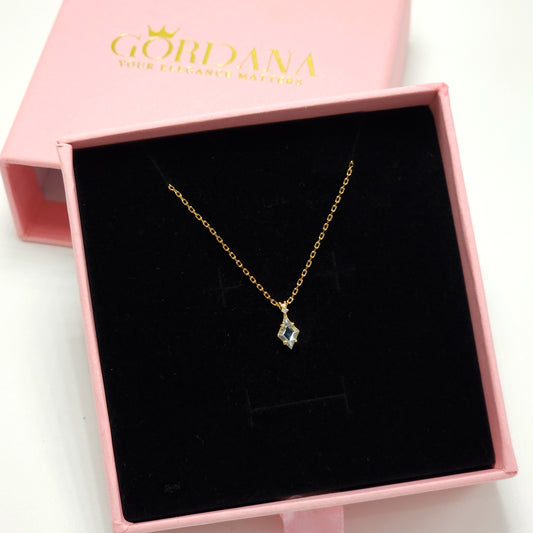 Silver and gold-tone stainless steel necklace with sky blue topaz gemstone, elegant unisex fashion jewelry.