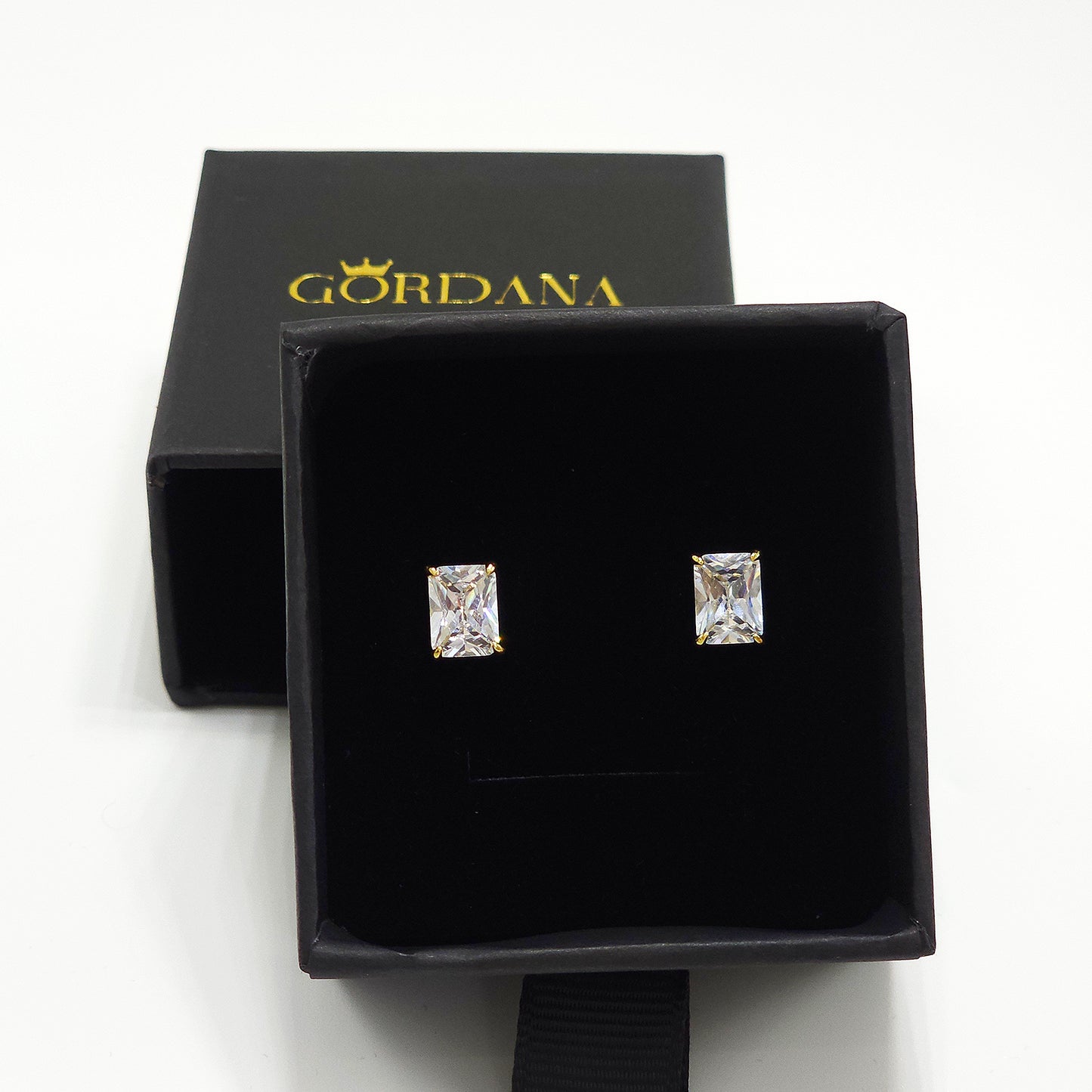18K gold plated Victoria earrings with rectangular clear gemstones in black velvet box, elegant unisex fashion jewelry.