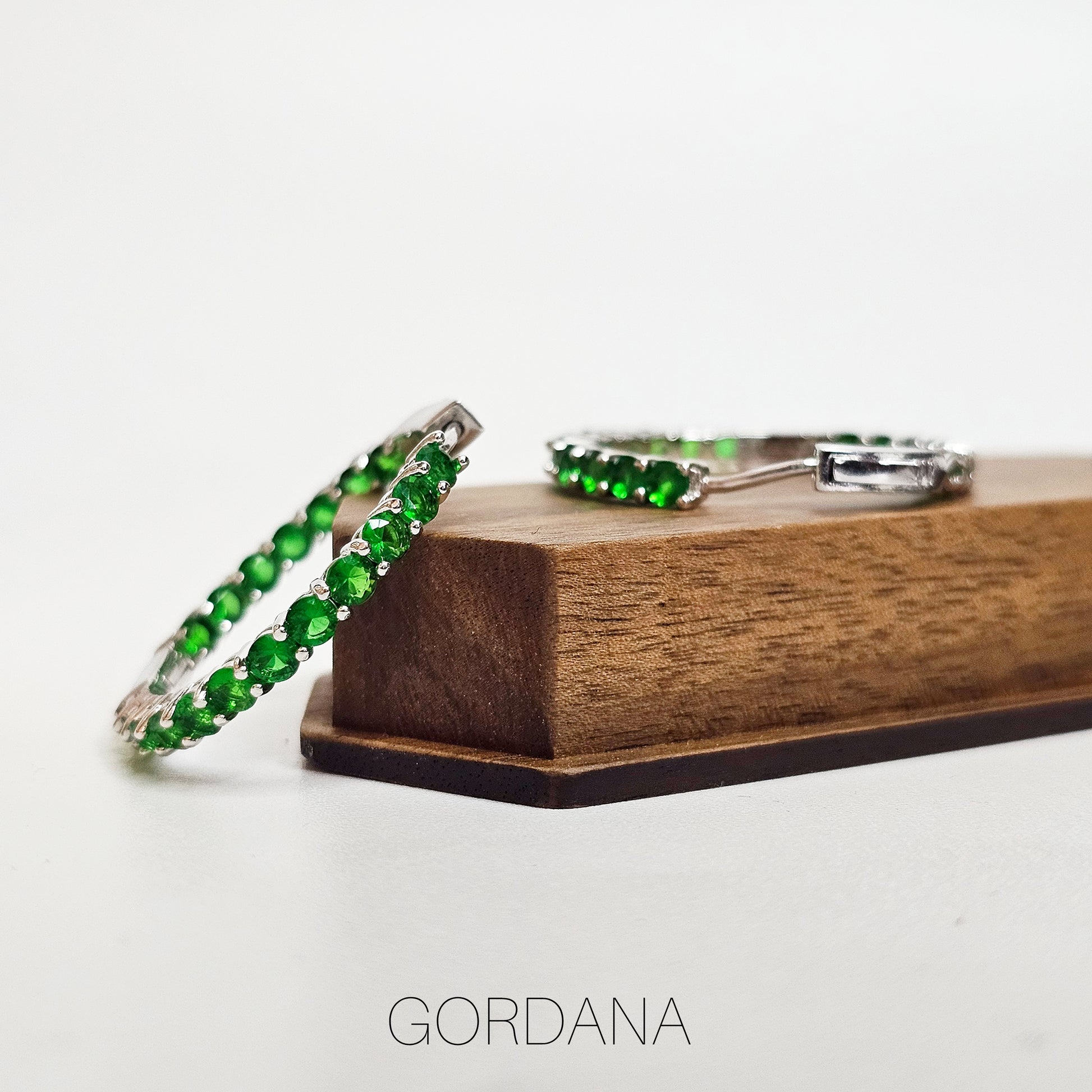 Silver stainless steel hoop earrings with green gemstones, elegant unisex fashion jewelry from Mauritius Europe USA style.