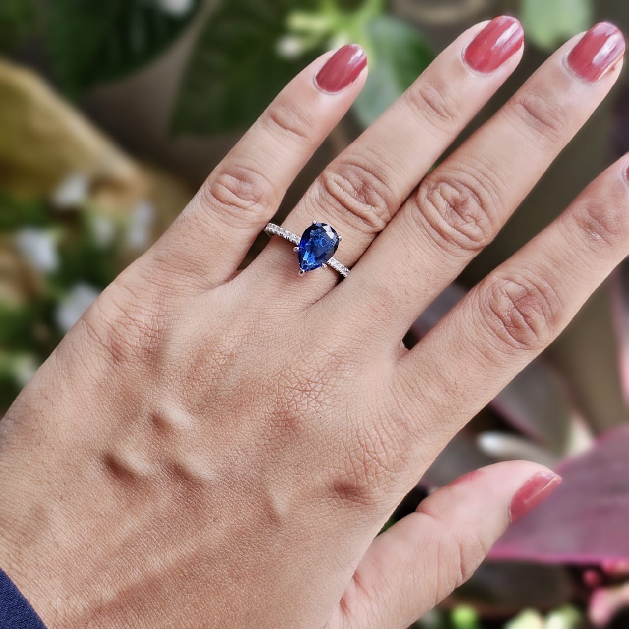Silver jewelry ring with a pear-shaped blue gemstone, elegant stainless steel fashion jewelry, unisex Mauritius Europe USA.