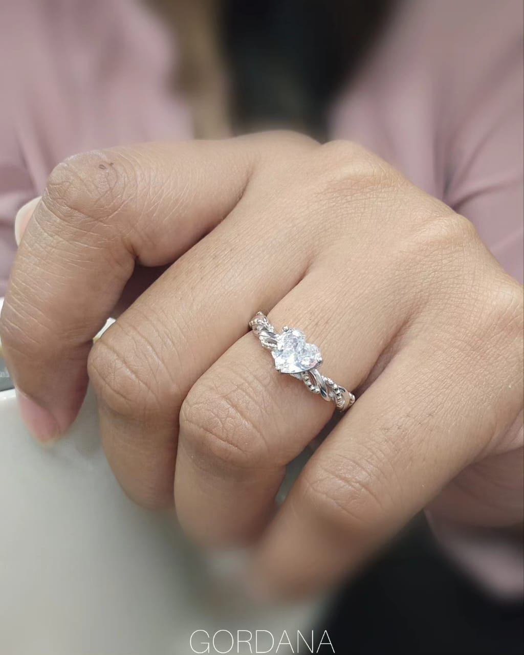 Silver stainless steel promise ring with a central teardrop gemstone flanked by smaller round stones, unisex design.
