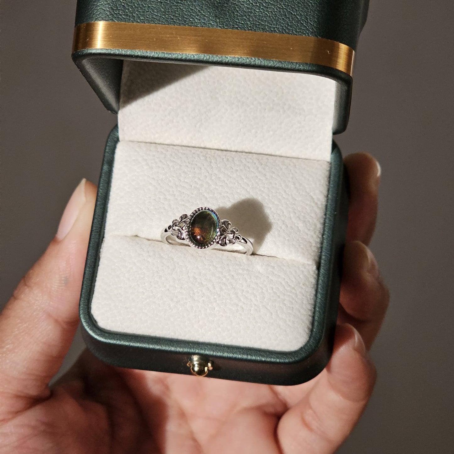 Silver gemstone mood ring with intricate band design in a black velvet box, unisex stainless steel jewelry, Mauritius Europe .