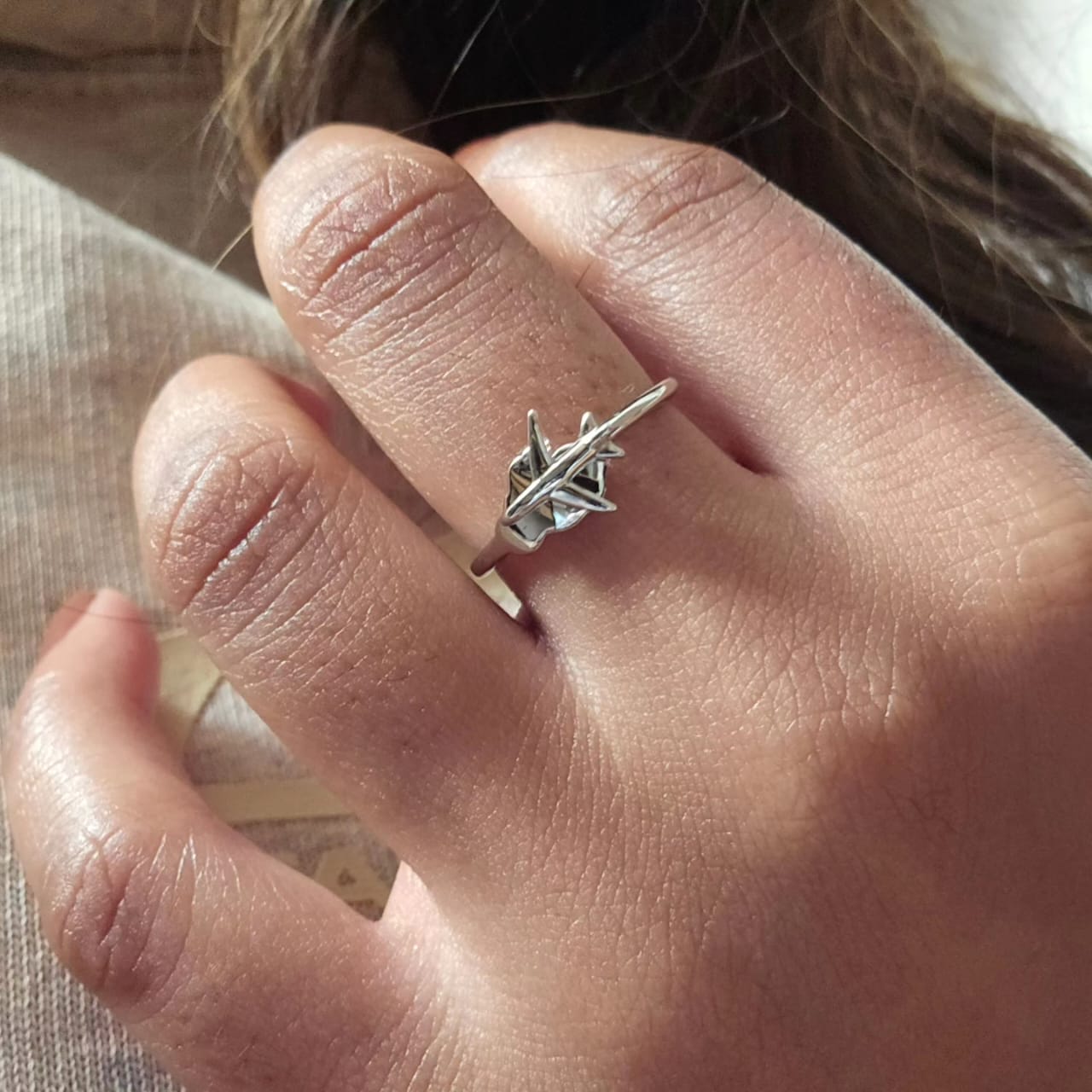 Silver stainless steel ring with a geometric origami crane design, unisex style.