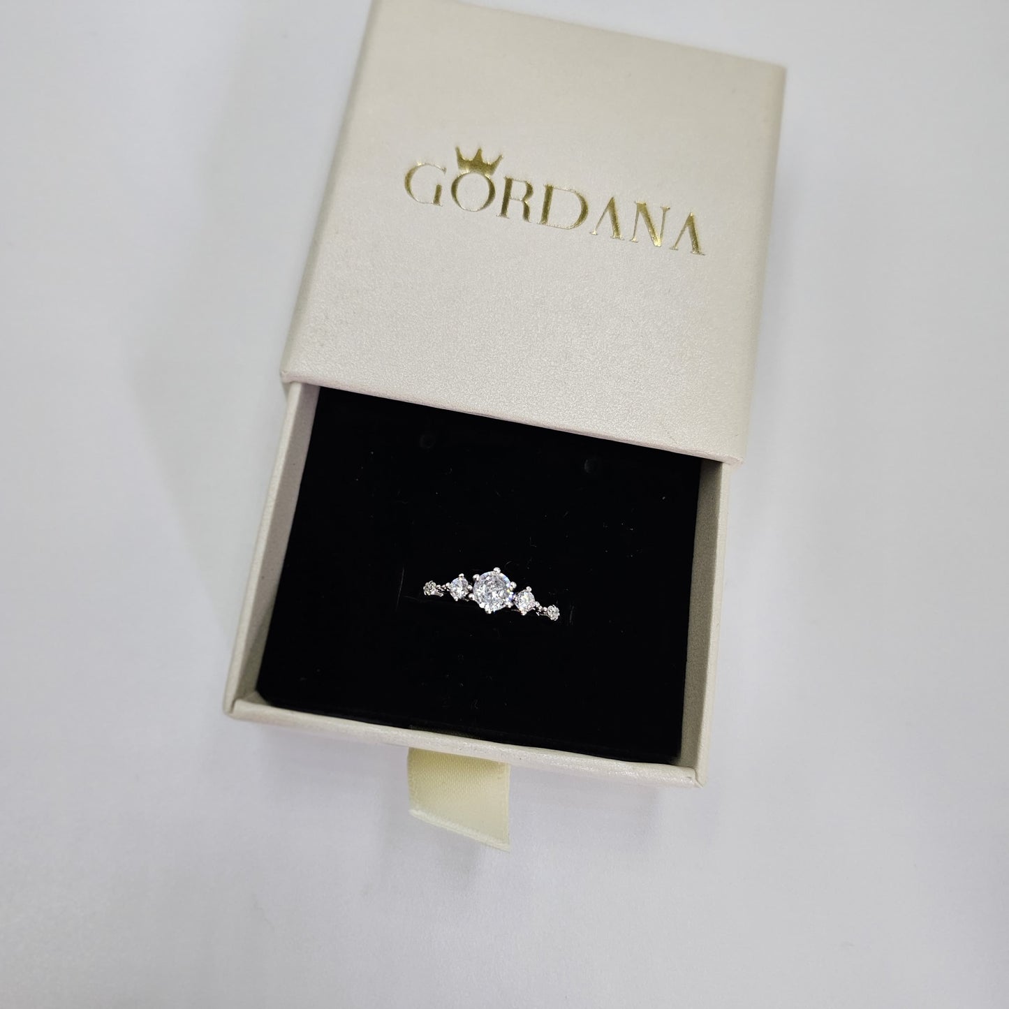 Silver promise ring with three clear gemstones in a delicate stainless steel setting, unisex fashion jewelry from Mauritius.