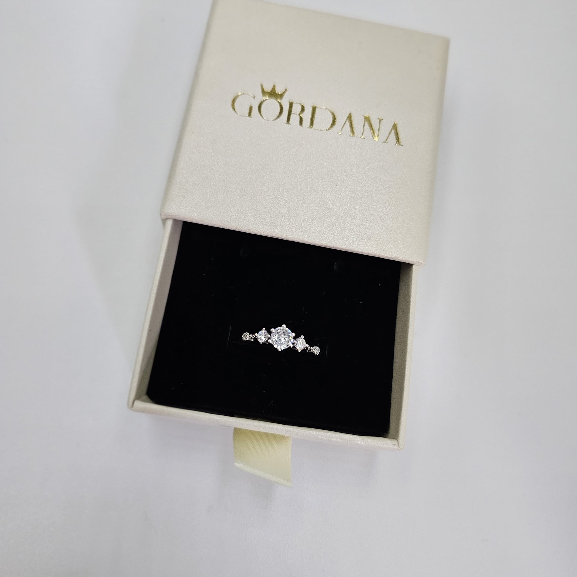 Silver promise ring with three clear gemstones in a delicate stainless steel setting, unisex fashion jewelry from Mauritius.