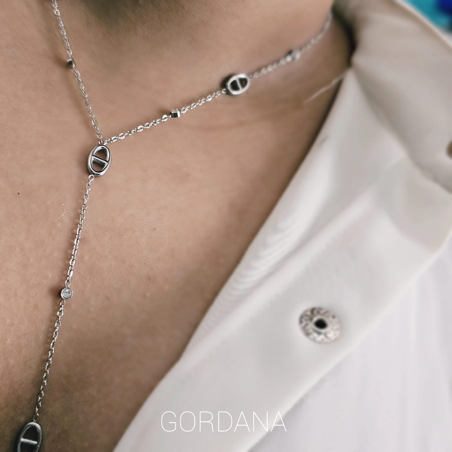 Silver stainless steel necklace with oval and circular links, delicate chain and subtle shine.