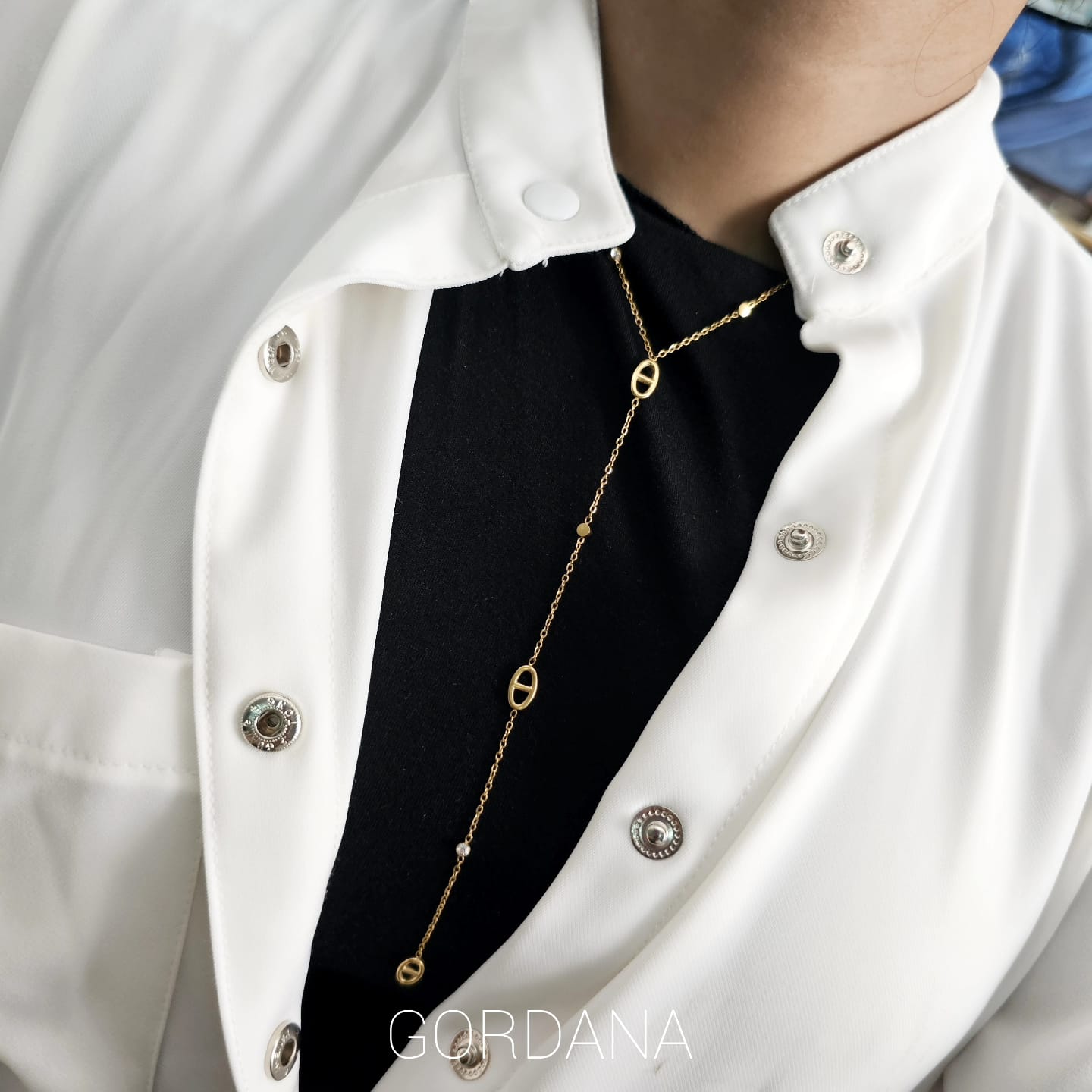 Elegant gold stainless steel necklace with delicate chain and circular links, unisex fashion jewelry.