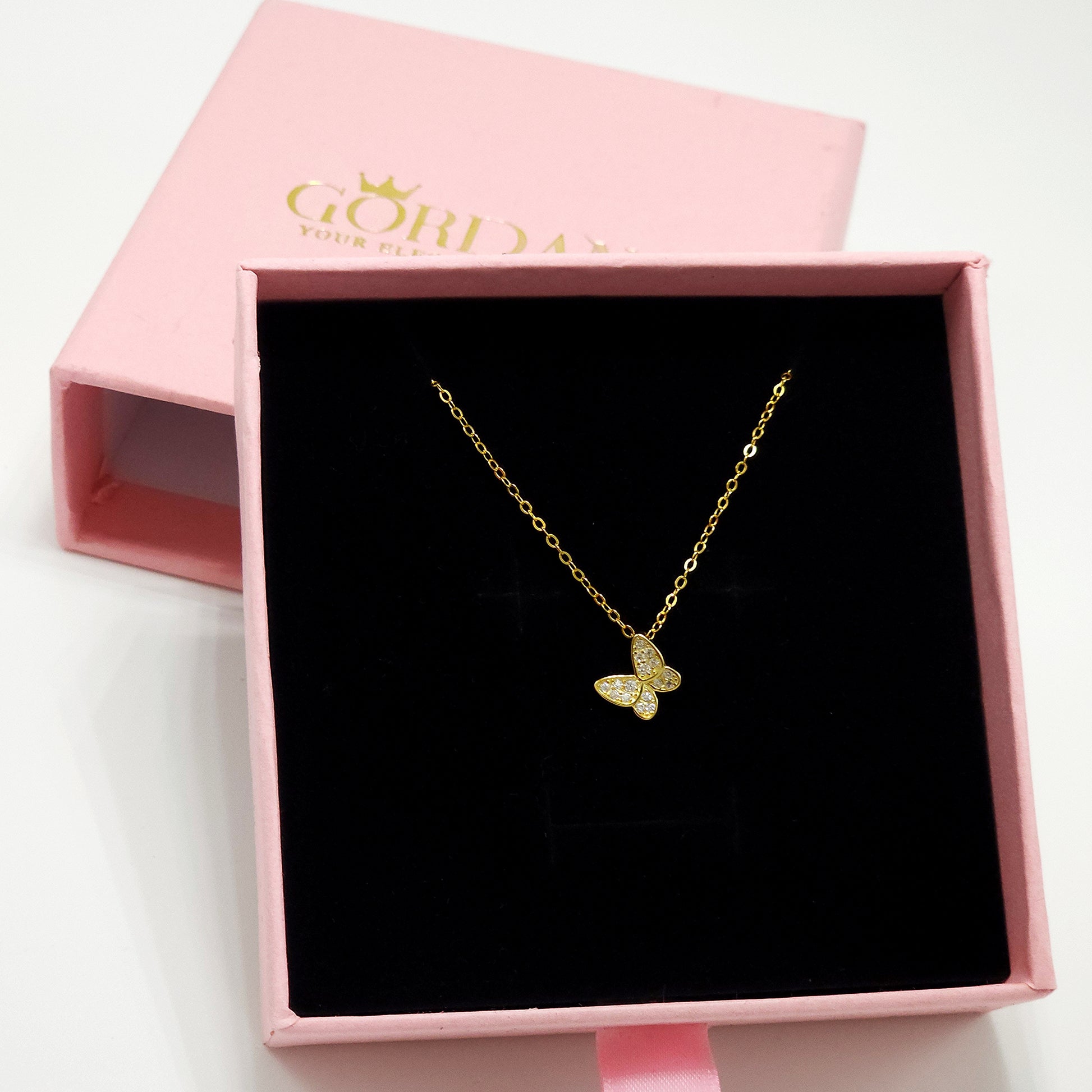 Gold butterfly pendant necklace on delicate chain in pink box, elegant stainless steel jewelry, unisex fashion jewelry.