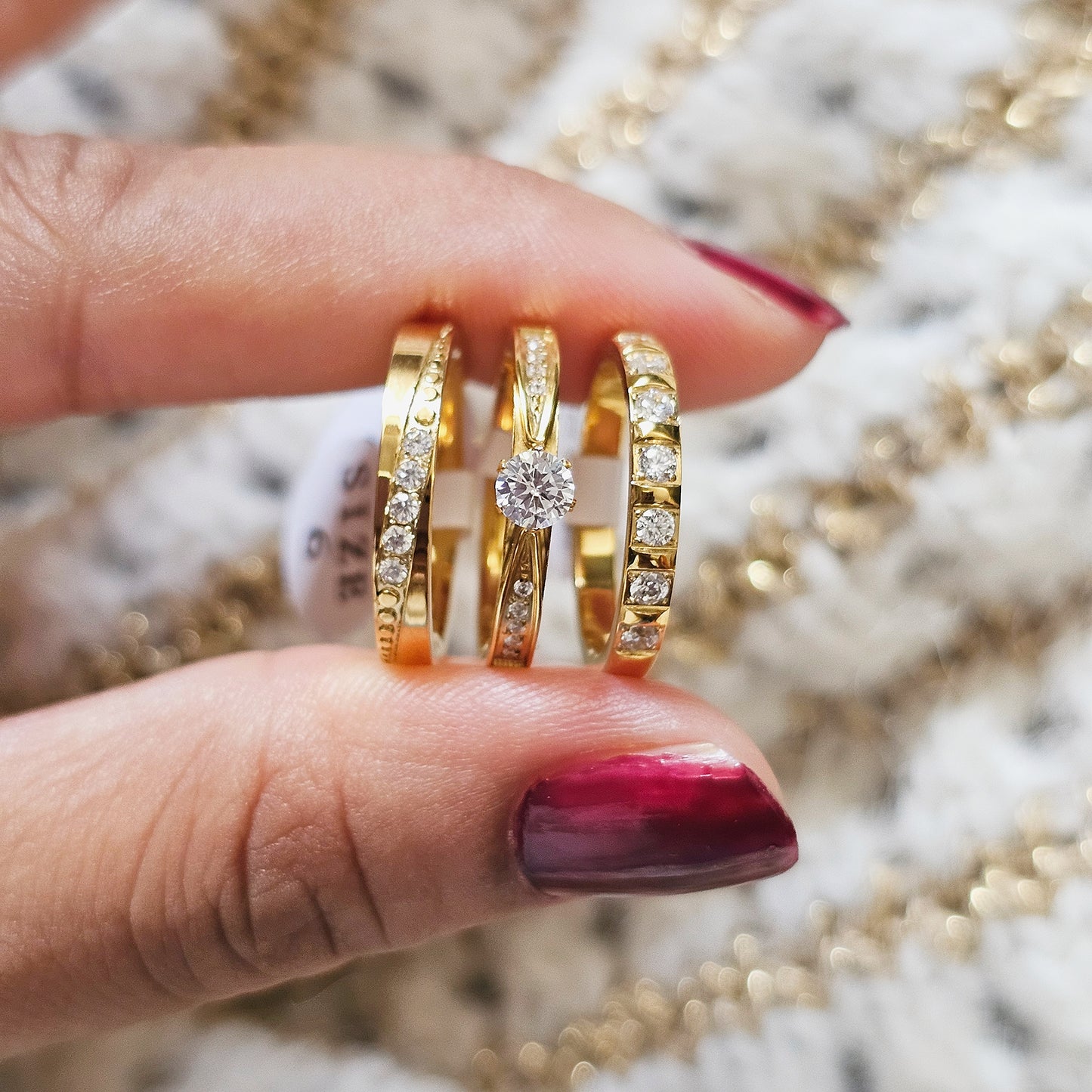 Gold rings stack with diamonds on a blurred jewelry background