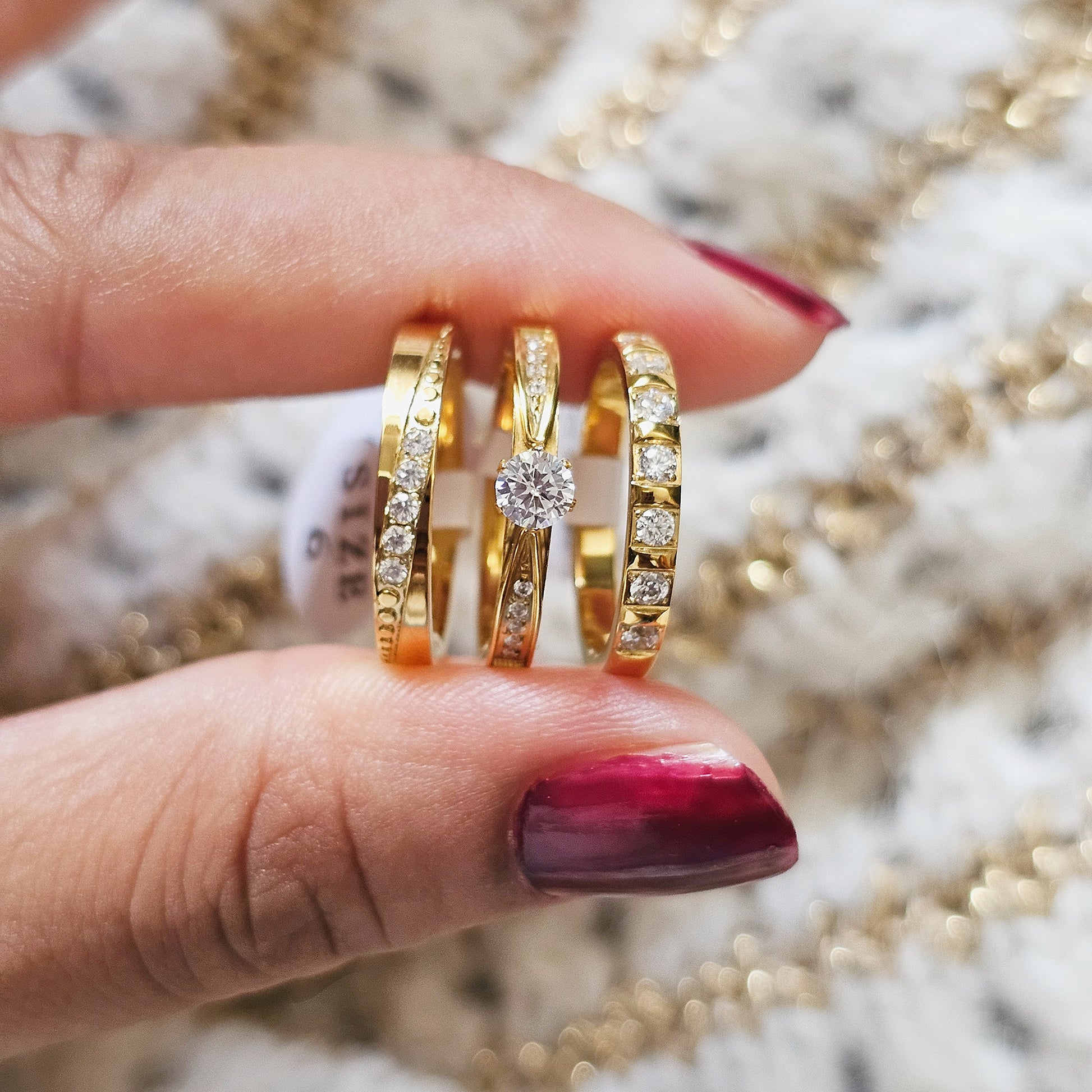 Gold rings stack with diamonds on a blurred jewelry background