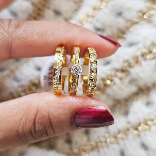Gold rings stack with diamonds on a blurred jewelry background