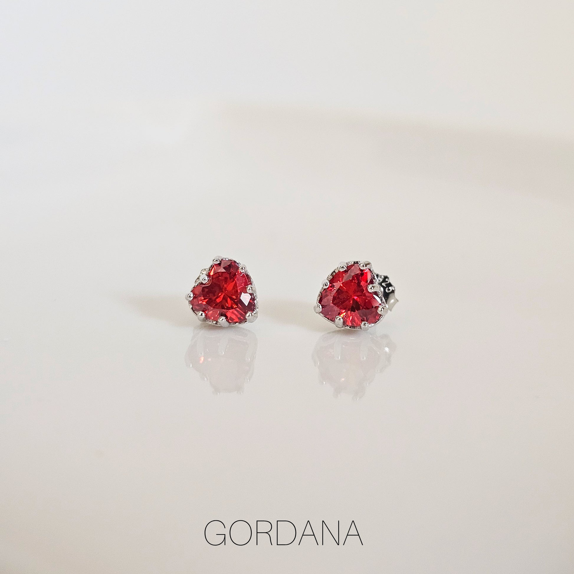 Scarlet red heart-shaped gemstone earrings in silver stainless steel, fashion jewelry for unisex style.