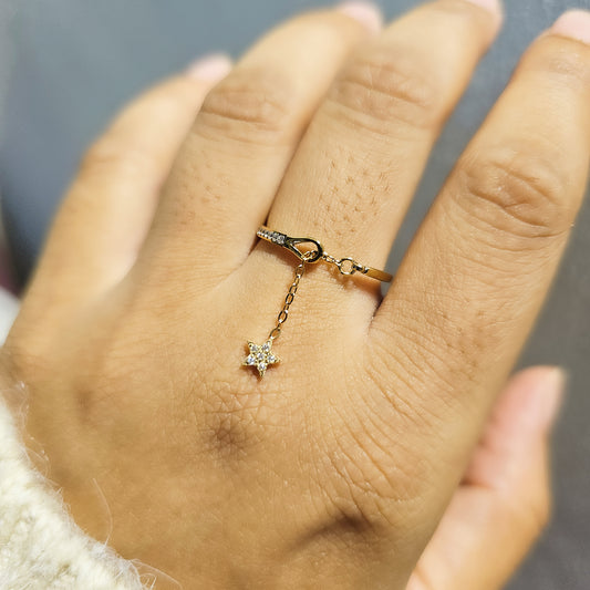 hand wearing gold chain ring with star pendant with diamonds