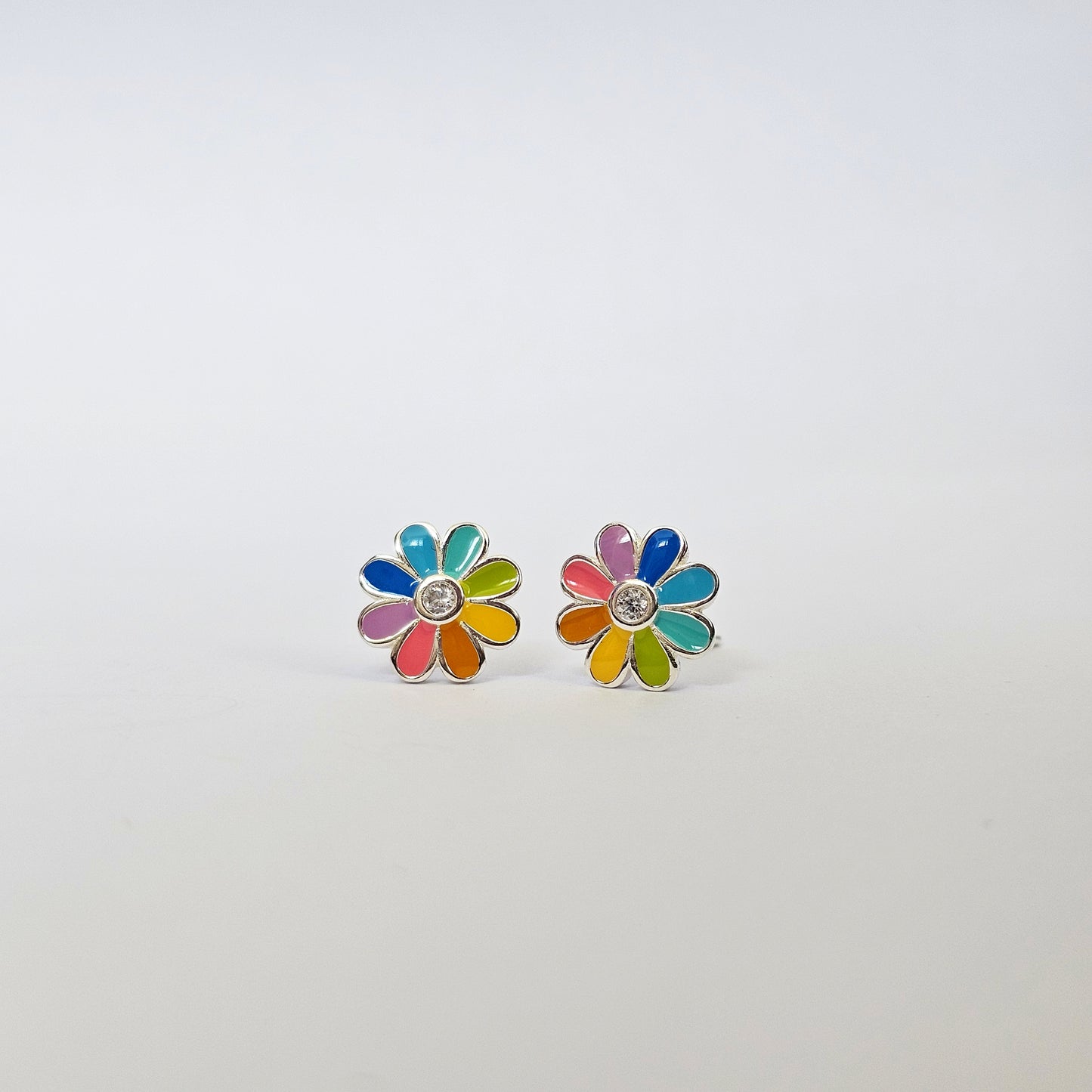 Silver stud earrings shaped like colorful daisy flowers with multicolored gemstone petals, stainless steel jewelry, unisex.