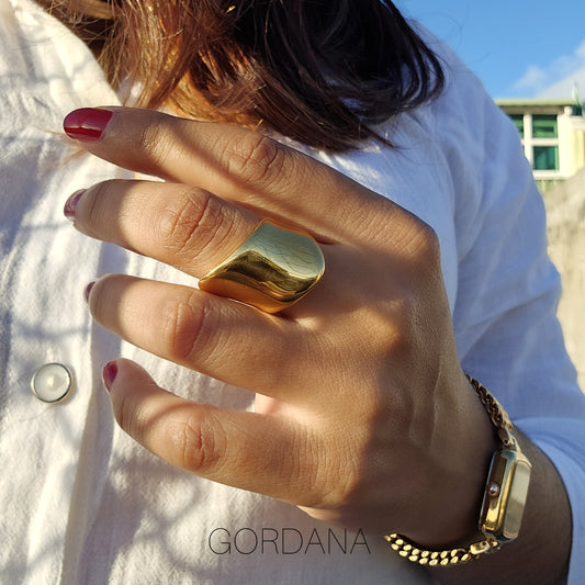 Bold 18K gold plated stainless steel ring on finger, elegant silver jewelry for unisex fashion.