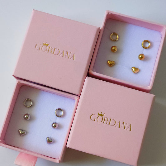 Trio set of gold and silver stainless steel fashion earrings with gemstone accents in pink Gordana boxes.